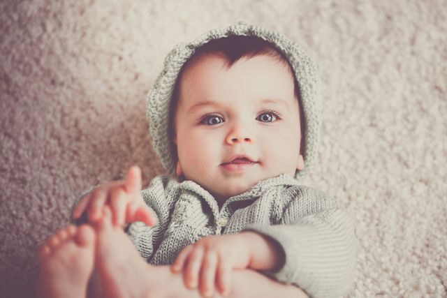 Best Winter Baby Clothes of 2022. Baby lying down in winter clothes.