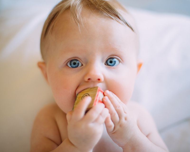 5 Fab Subscription Boxes for New Parents, adorable baby chewing on a wooden block