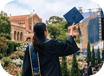 A graduate raising her cap outside after the ceremony