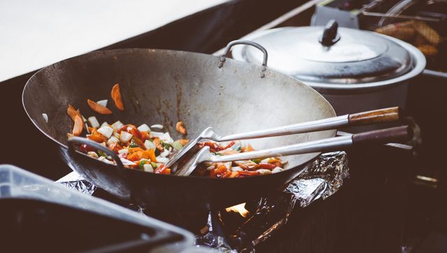 Best Cookware of 2019, stir fry getting fried in a dish on the stove. Next to it is a pan with a lid on it.